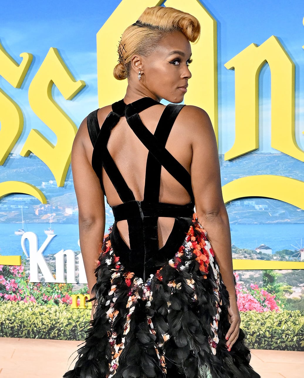 Janelle Monáe styles her tresses in 1940s victory rolls and wears minimal makeup