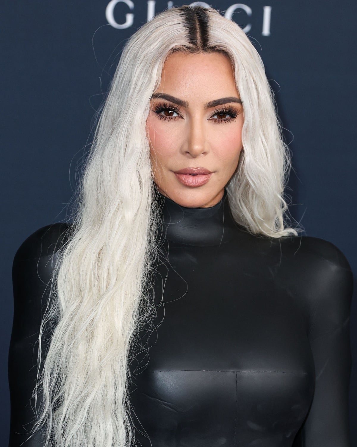 Kim Kardashian stuns in a form-fitting black vinyl gown, accentuating her platinum blonde waves and flawless makeup at the 11th Annual LACMA Art + Film Gala