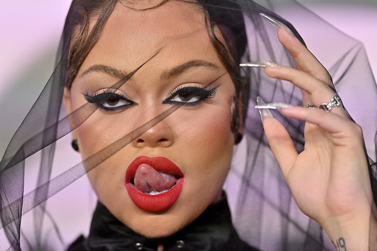 Latto keeps things sultry with cat eye flick and bold red lipstick