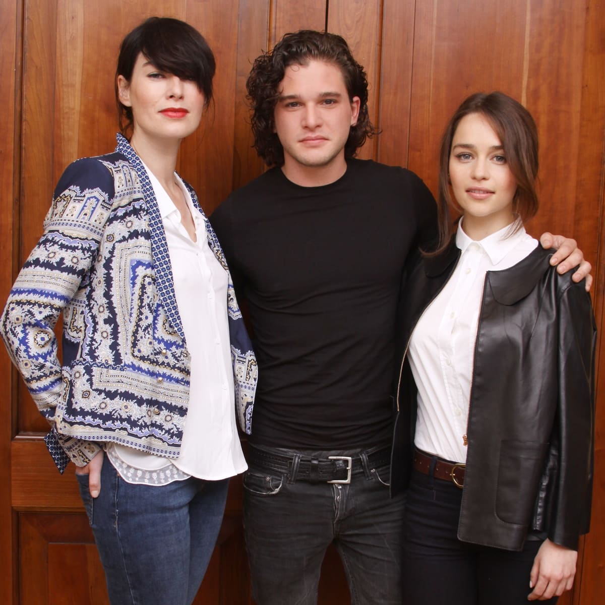 Emilia Clarke (R), just 5ft 2 (157.5 cm), appears noticeably shorter beside her taller Game of Thrones co-stars Lena Headey and Kit Harington at the press conference held at The Grosvenor House Hotel in London on May 14, 2012 — looking polished in a crisp white blouse layered under a black leather jacket