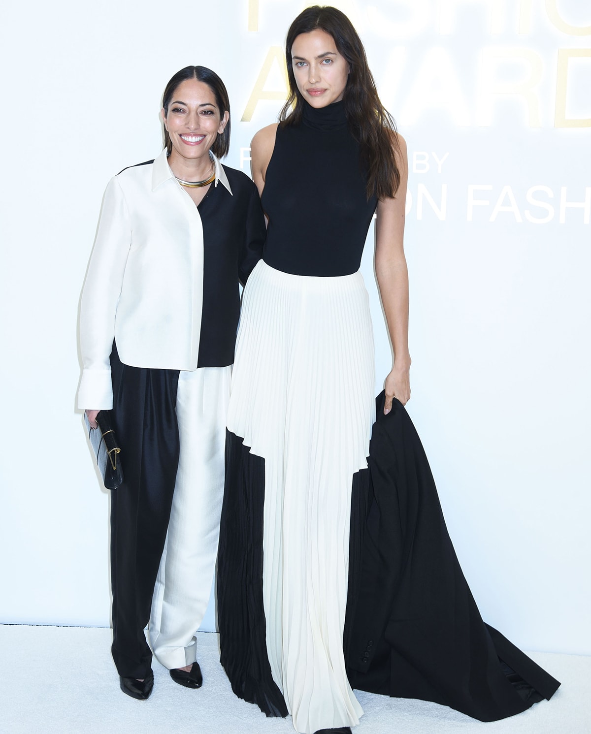 Bare-faced Irina Shayk stands noticeably taller beside designer Nellie Partow at the CFDA Fashion Awards on November 7, 2022, highlighting their striking height difference in coordinated monochrome looks
