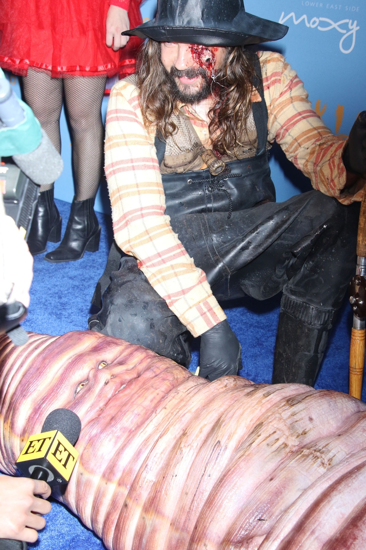 Ever committed to her role, Heidi Klum did interviews while lying on the ground with husband Tom Kaulitz fondly watching over her