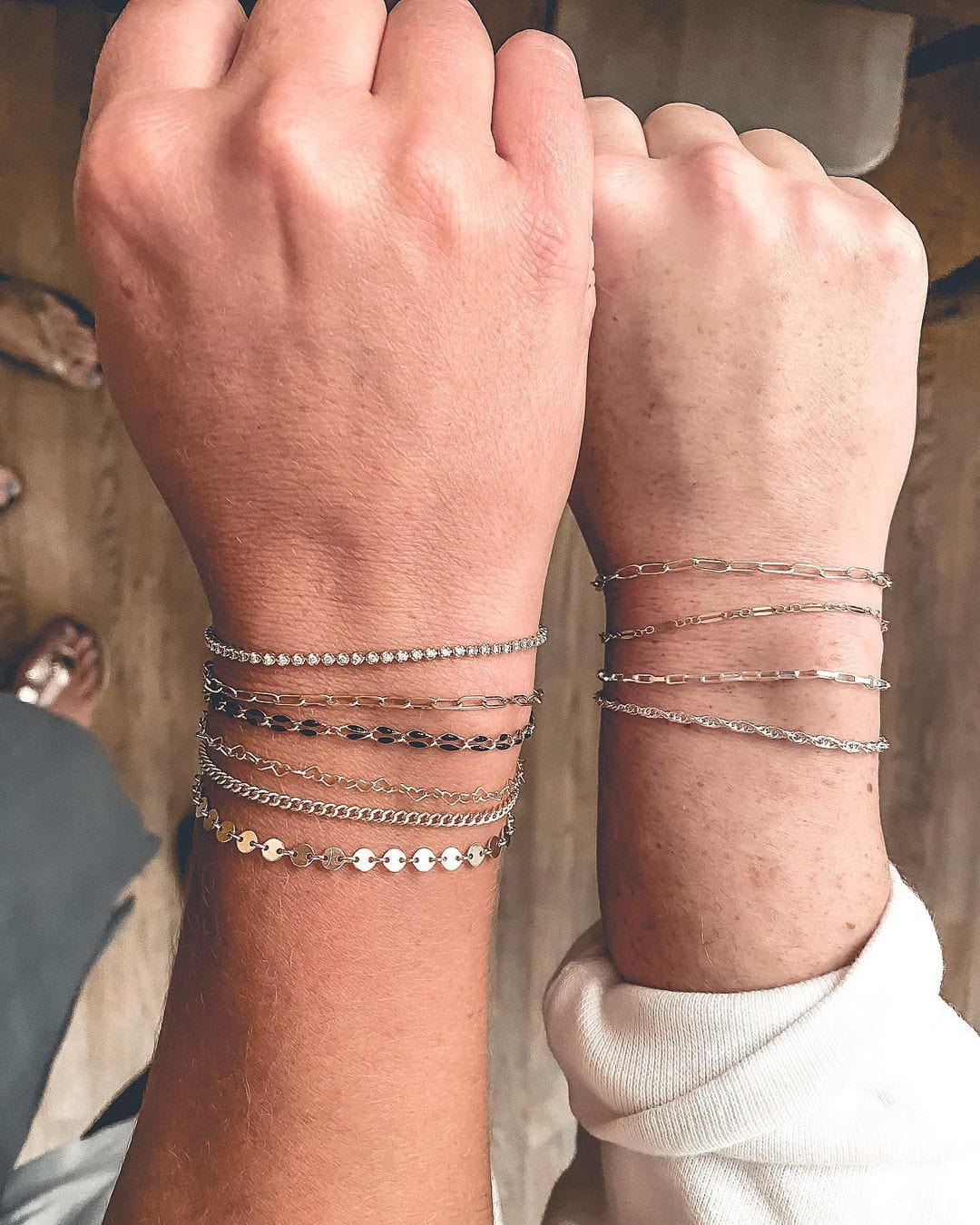Matching silver welded bracelets layered on both wrists highlight the personalized and enduring appeal of permanent jewelry