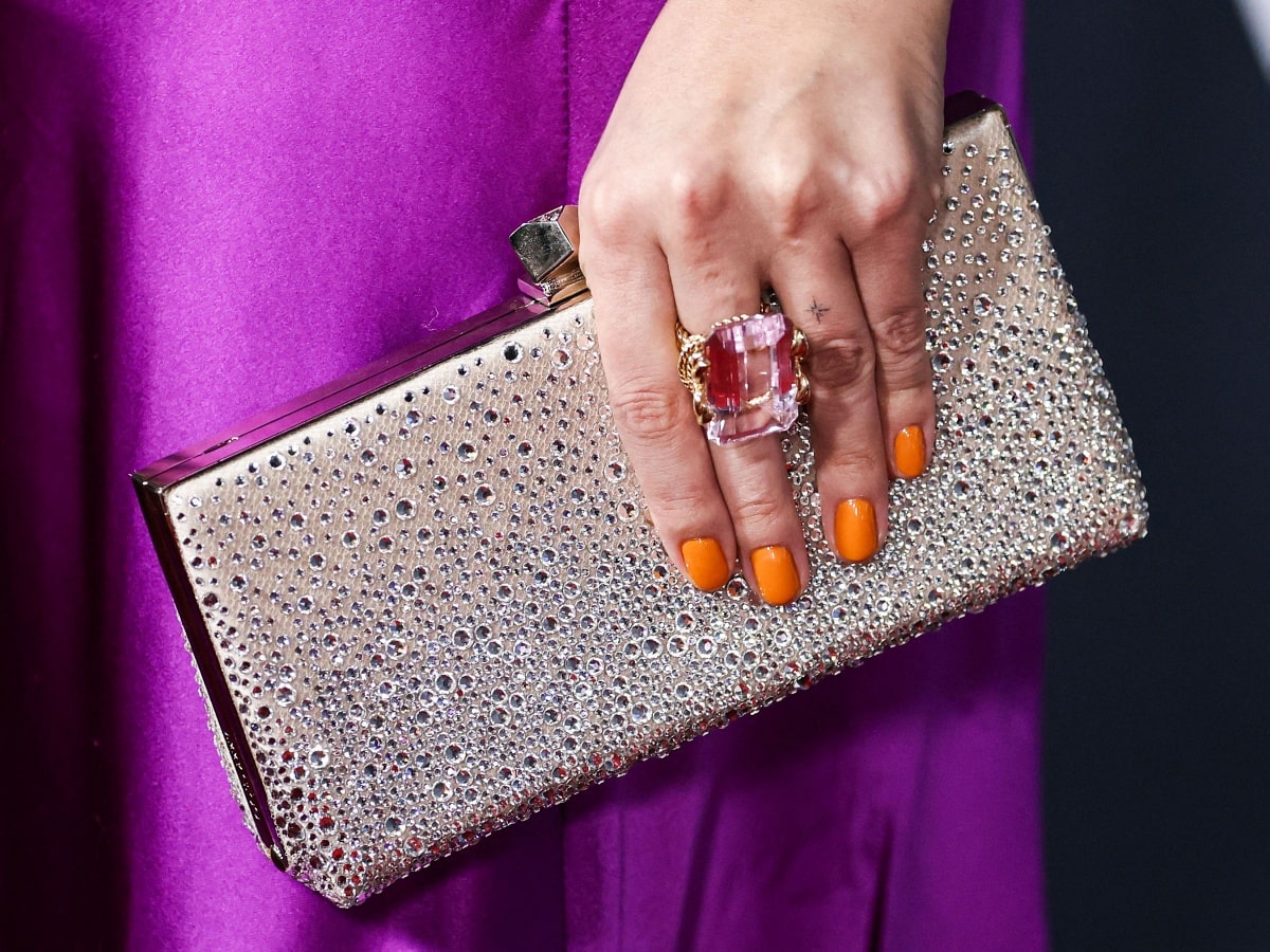 Selena Gomez with a David Webb Kunzite ring and Jimmy Choo Celeste crystal-embellished clutch