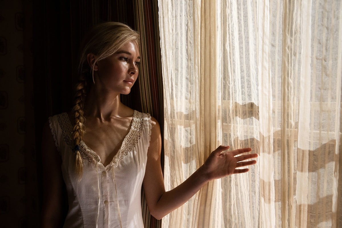 Dressed in a delicate vintage-style chemise, Isabel May appears in character as Elsa Dutton in 1883—a poignant moment from the series before her character’s emotional farewell, which was pivotal to the storyline