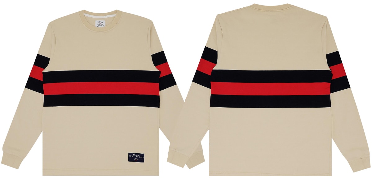 A classy take on the classic rugby crewneck, this Noah creation is done in Vegas Gold with navy and dark red stripes across the front and sleeves
