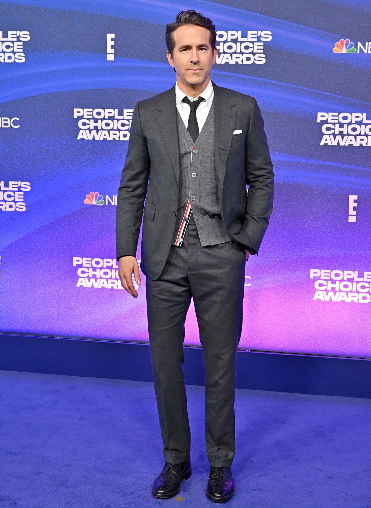 People’s Icon honoree Ryan Reynolds opts for understated polish in a dark gray three-piece Thom Browne suit, finished with classic black lace-up dress shoes