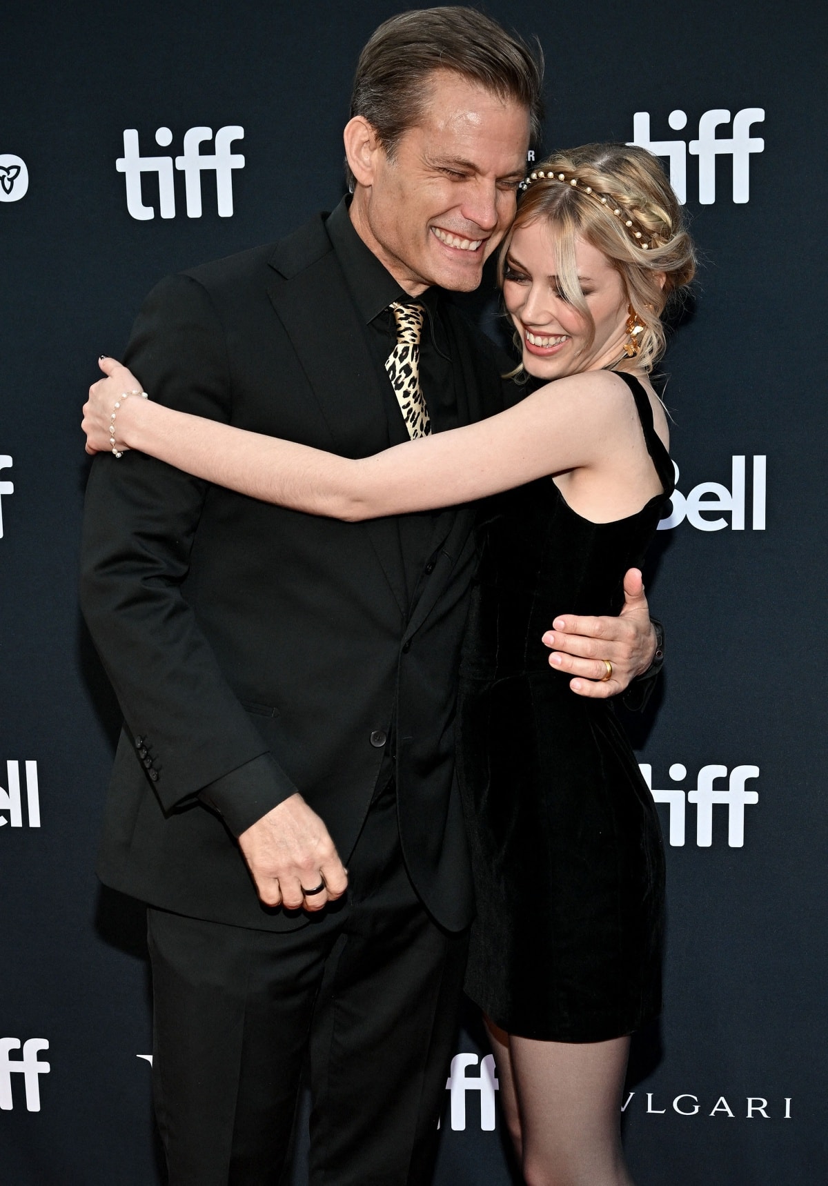 Grace Van Dien shares a heartwarming hug with her father, Casper Van Dien, at the premiere of Roost during the 47th Toronto International Film Festival on September 15, 2022