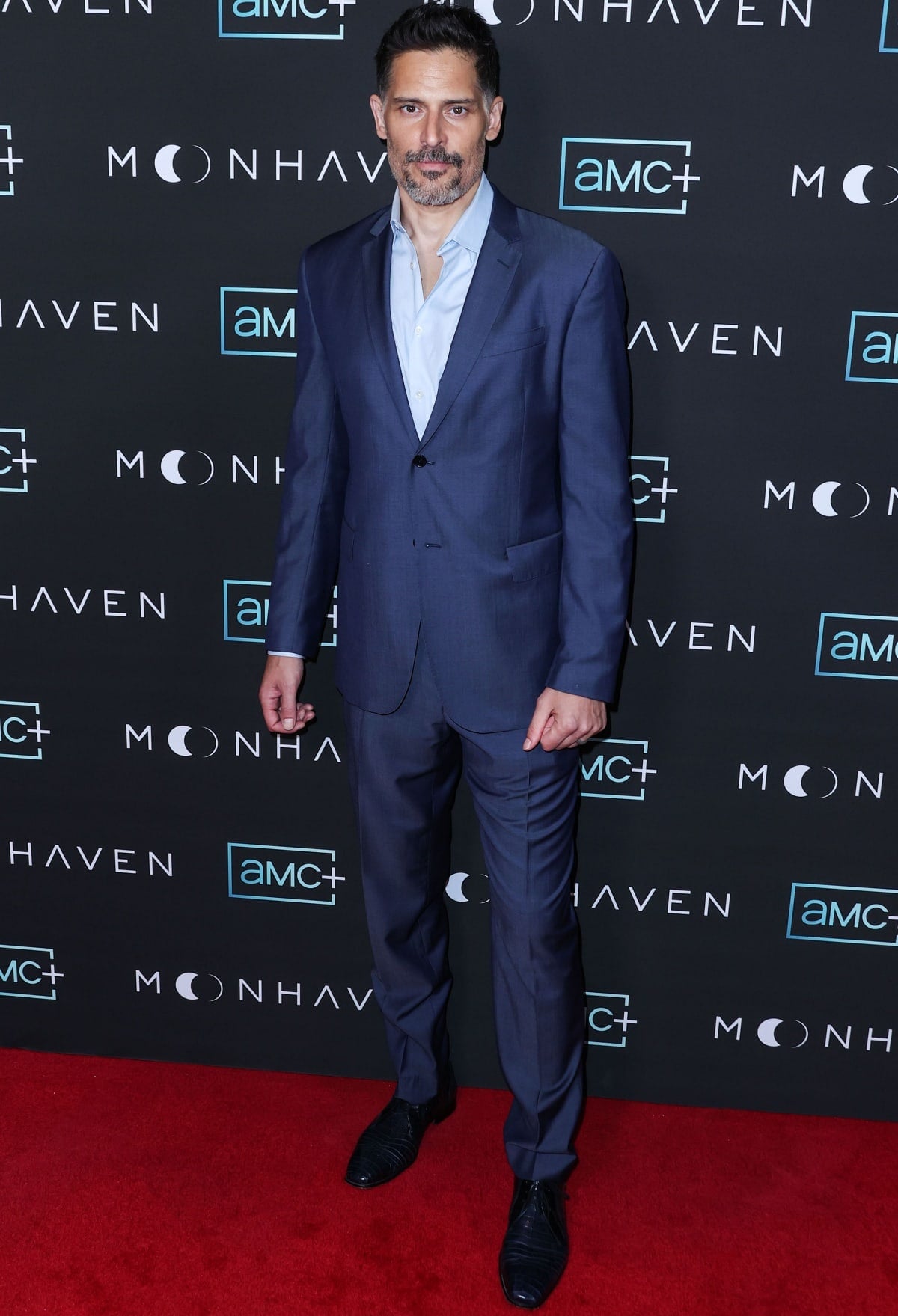 Joe Manganiello, standing tall at 6'4 ¾" (194.9 cm), brought effortless polish to the Moonhaven premiere in Los Angeles in a sharp slate-blue suit, open-collar shirt, and sleek black dress shoes that highlighted his understated red carpet charm