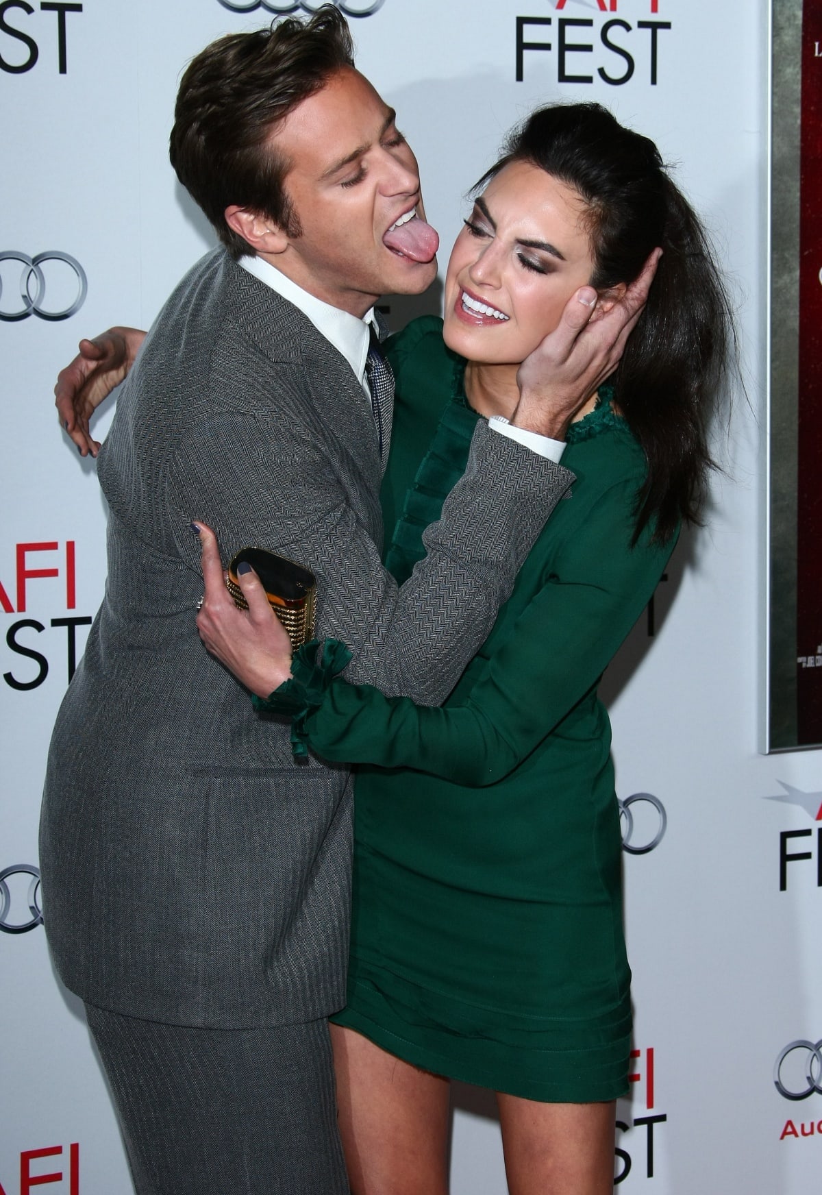 Armie Hammer shared a playful moment with then-wife Elizabeth Chambers—who stunned in a forest green mini dress—at the J. Edgar opening night gala during AFI Fest 2011 in Los Angeles on November 3, bringing both charm and chaos to the red carpet