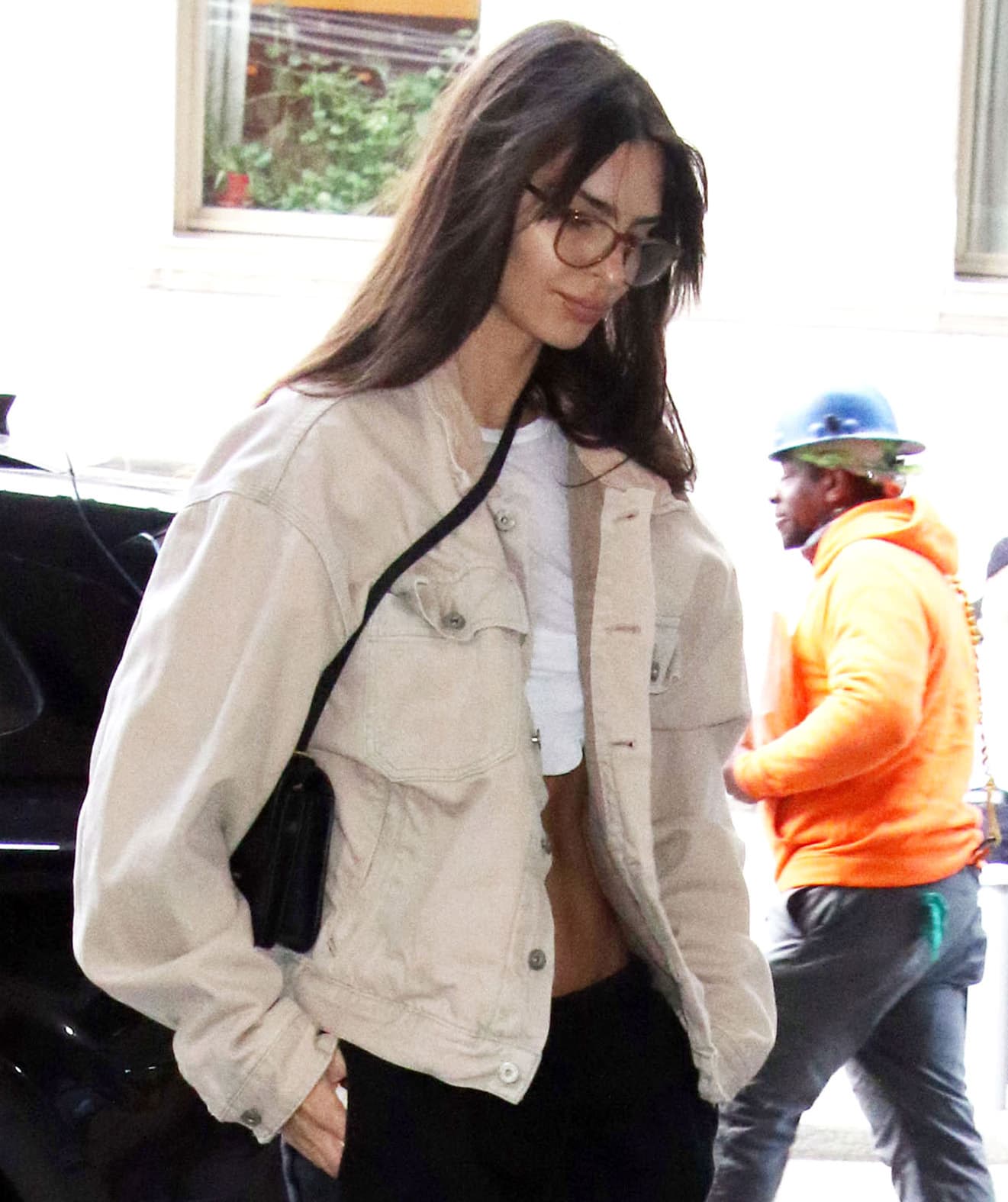 Emily Ratajkowski looks fresh with barely-there makeup, fringed hairstyle, and eyeglasses