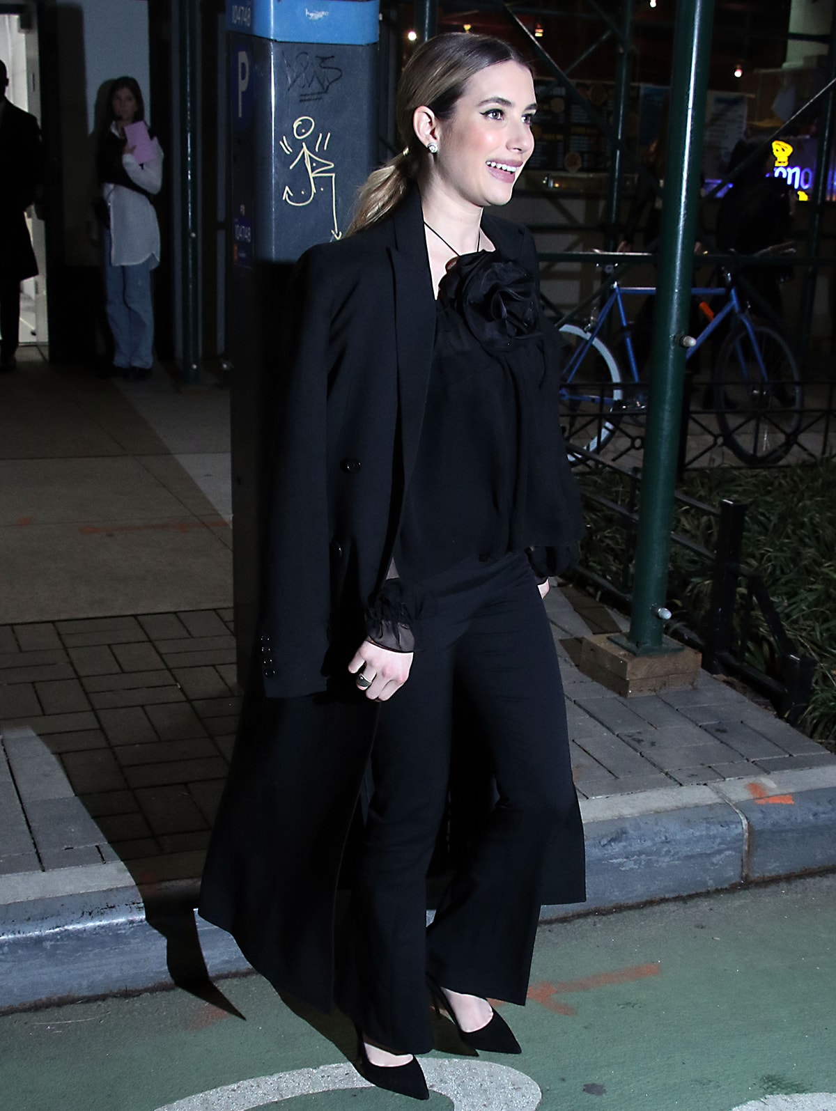 Emma Roberts wears a trendy corsage-embellished blouse by Carolina Herrera for her appearance on Watch What Happens Live on January 17, 2023