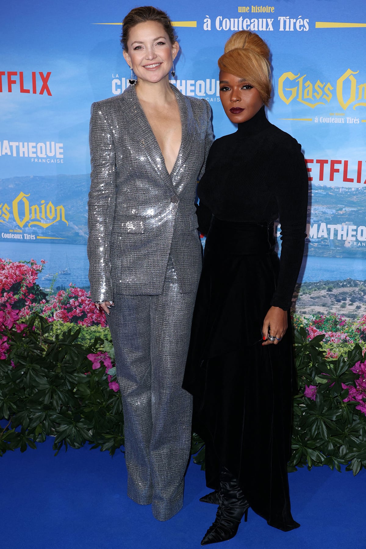 Kate Hudson poses with Janelle Monáe in a silver sequin co-ord suit by Pamella Roland, noticeably towering over her co-star on the Paris premiere red carpet