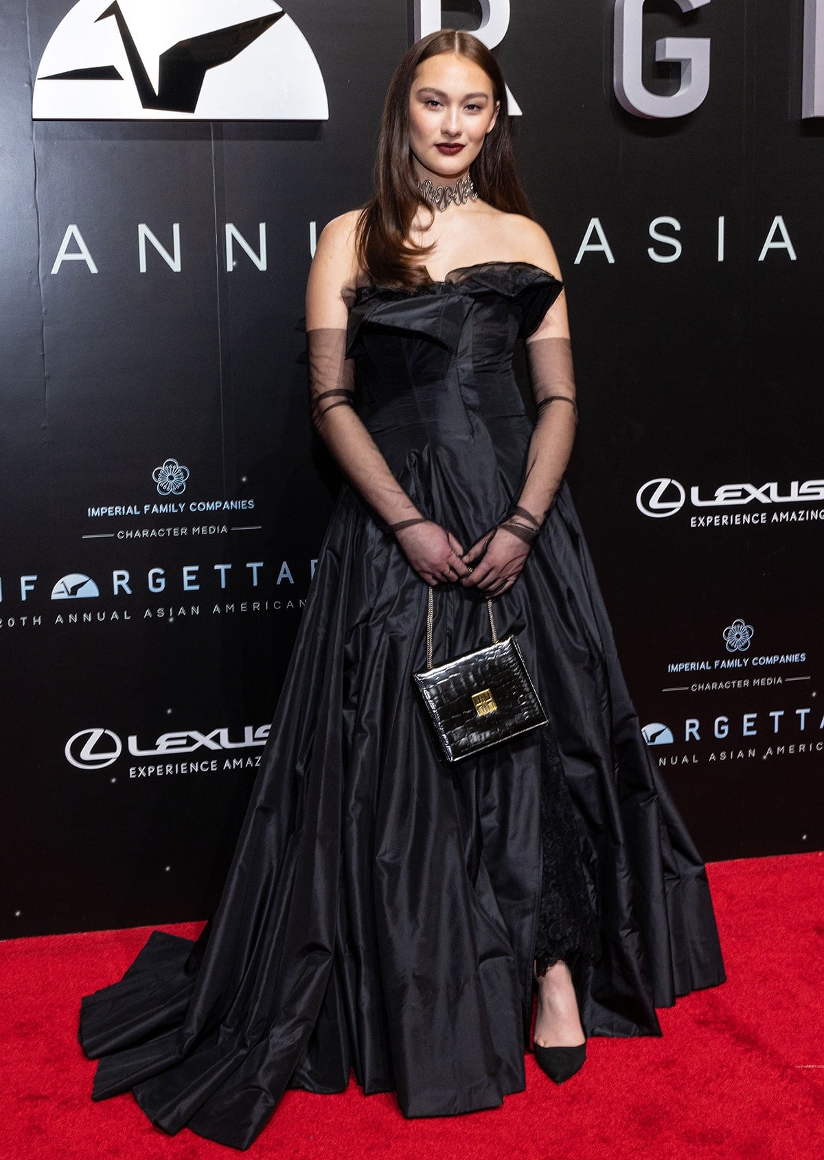 Lola Tung wearing a vintage Yohji Yamamoto Spring 1999 gown paired with black pumps and a Chris Habana tribal thorn choker at Unforgettable: The 20th Annual Asian American Awards held at the Beverly Hilton Hotel on December 18, 2022