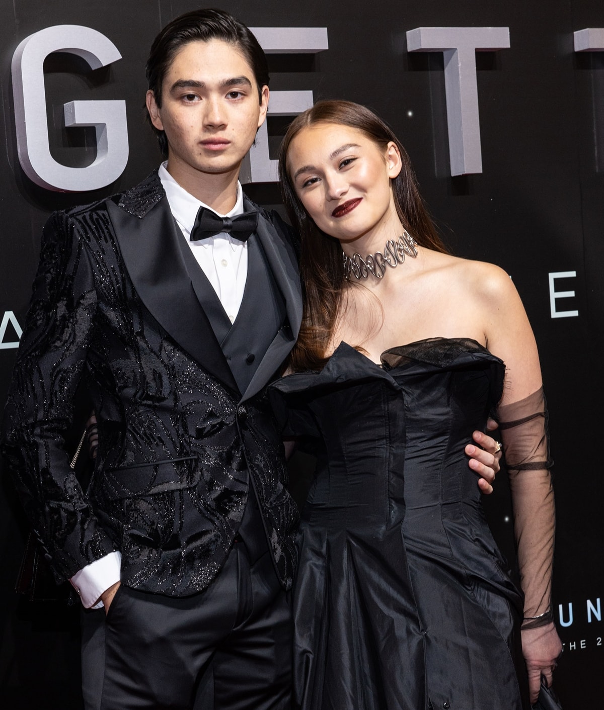 Lola Tung poses with her The Summer I Turned Pretty co-star Sean Kaufman at Unforgettable: The 20th Annual Asian American Awards, exuding gothic-glam sophistication in a vintage Yohji Yamamoto Spring/Summer 1999 gown