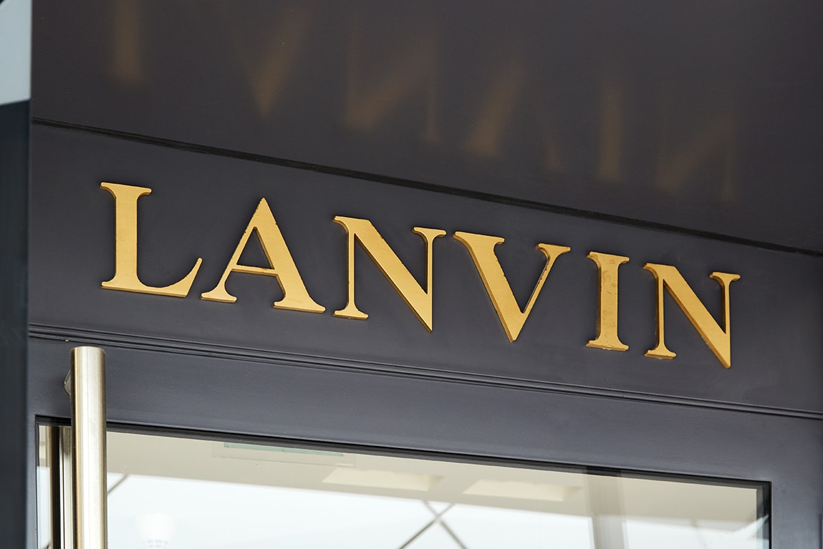 The Lanvin brand name, prominently displayed in gold lettering on a dark facade, signals the presence of a luxury fashion establishment