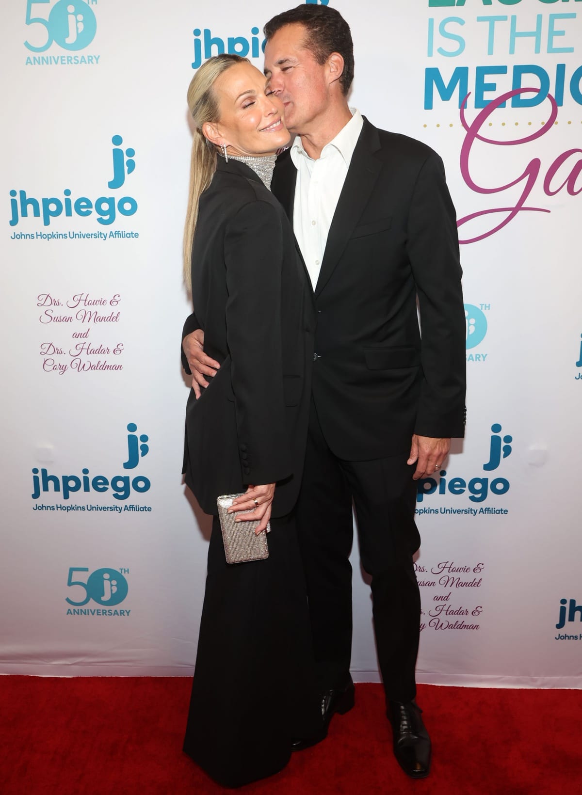 Molly Sims shared a red-carpet moment with husband Scott Stuber, wearing a sleek black suit styled with pointed-toe pumps and a glittering clutch