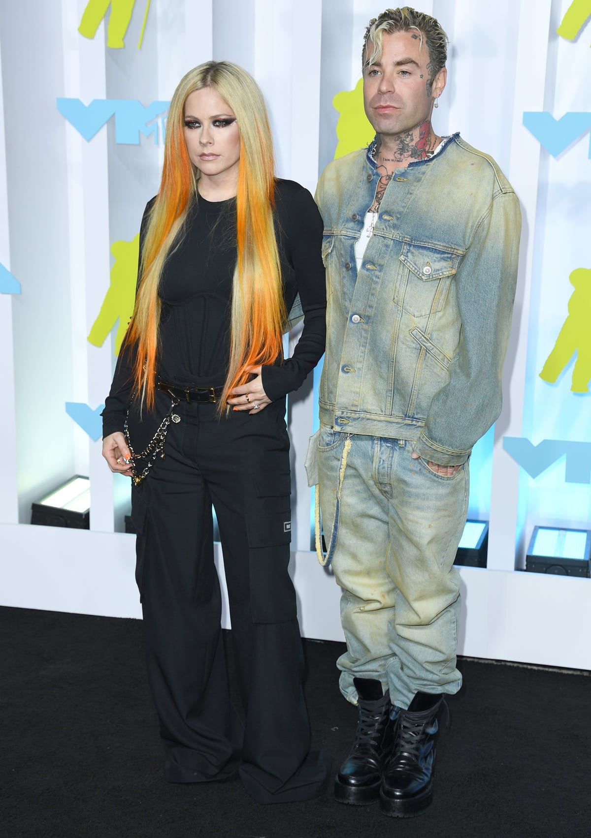Avril Lavigne and Mod Sun turned the 2022 MTV Video Music Awards red carpet into a pop-punk power moment, coordinating in edgy black and denim looks that perfectly reflected their shared rock aesthetic