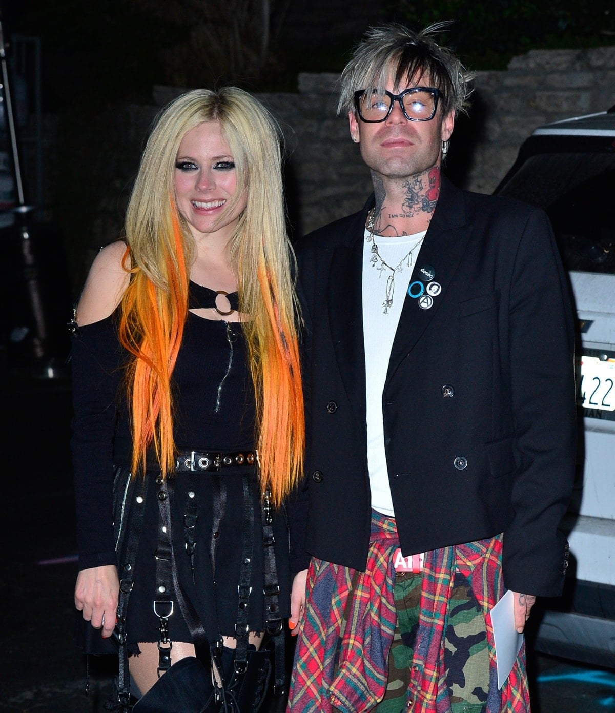 The couple perfectly embodied 2000s rebellion-meets-romance — Avril’s black harness mini and Mod Sun’s layered streetwear gave nostalgic Avril-era vibes with a grown-up edge