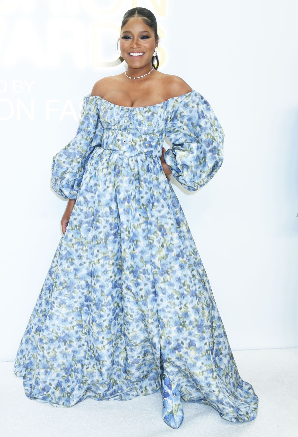 Keke Palmer glowed at the CFDA Fashion Awards in Carolina Herrera’s Spring 2023 “Secret Garden” gown, completing the romantic look with matching floral knee-high boots