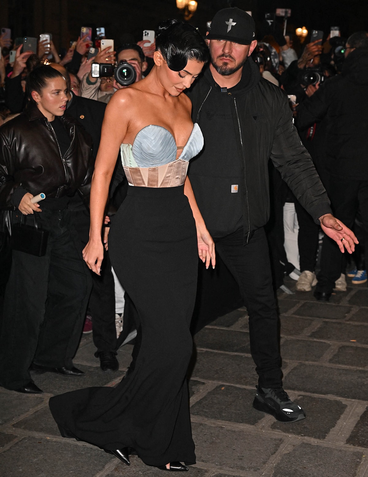 Kylie Jenner channeled archival glamour in a sculptural Jean Paul Gaultier Haute Couture gown and sharp pointed-toe pumps at the designer’s Spring/Summer 2023 show during Paris Fashion Week on January 25, 2023