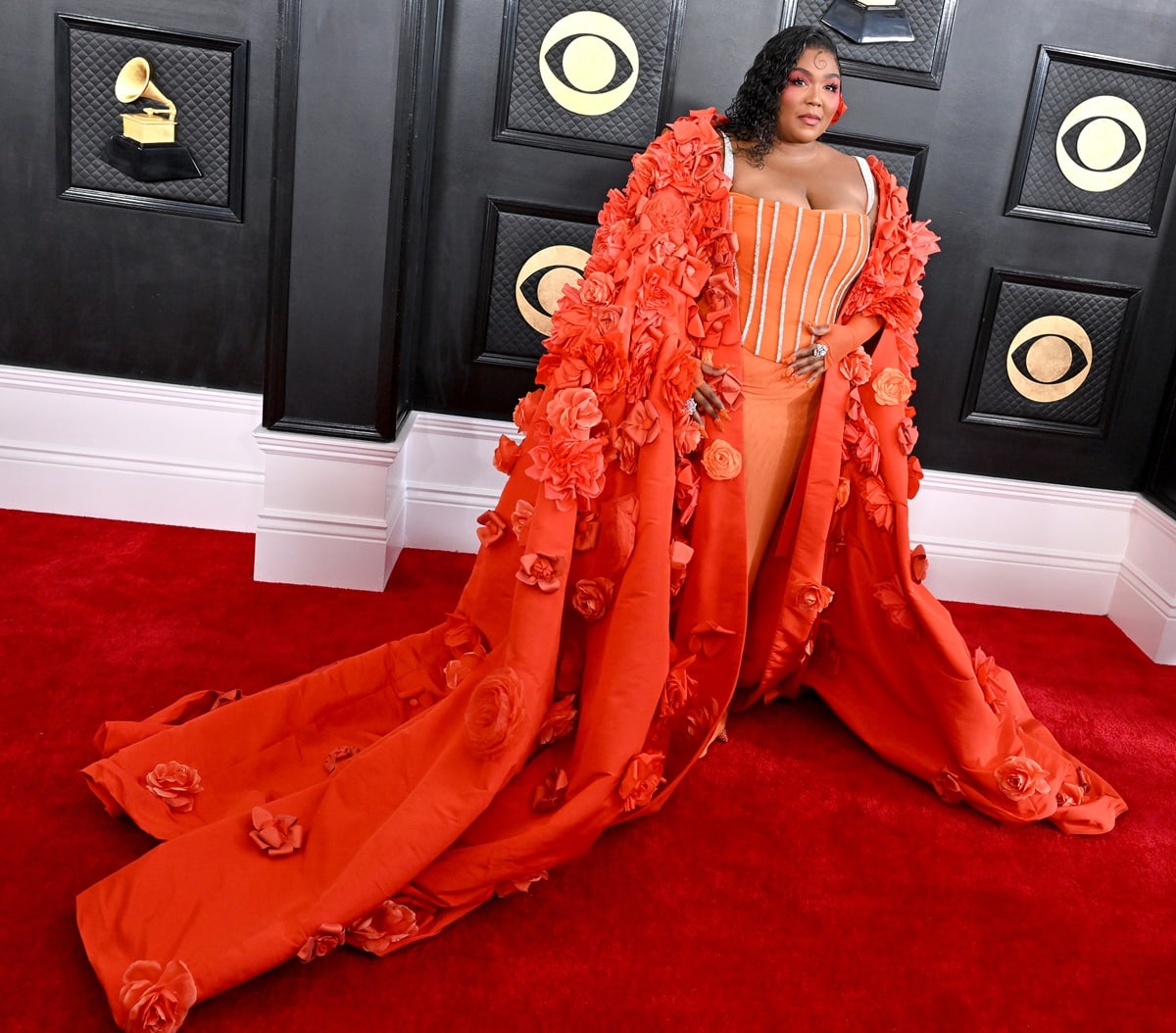 Lizzo wearing a custom Dolce Gabbana floral opera coat over a crystal-trimmed corset gown, completed with matching crystal-embellished heels
