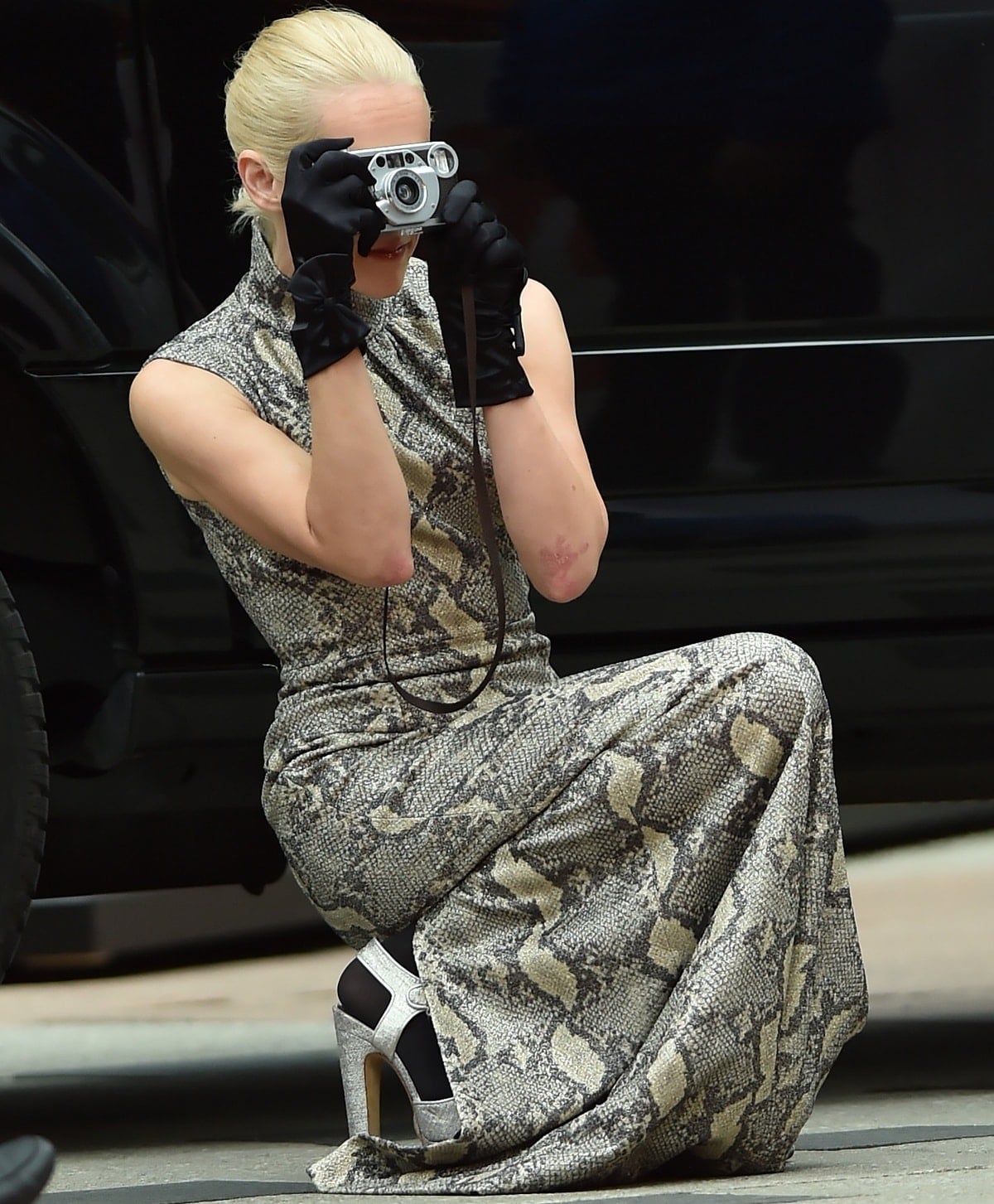 Jena Malone captures the moment in style, sporting silver platform heels that perfectly complement her snakeskin gown at the Toronto International Film Festival