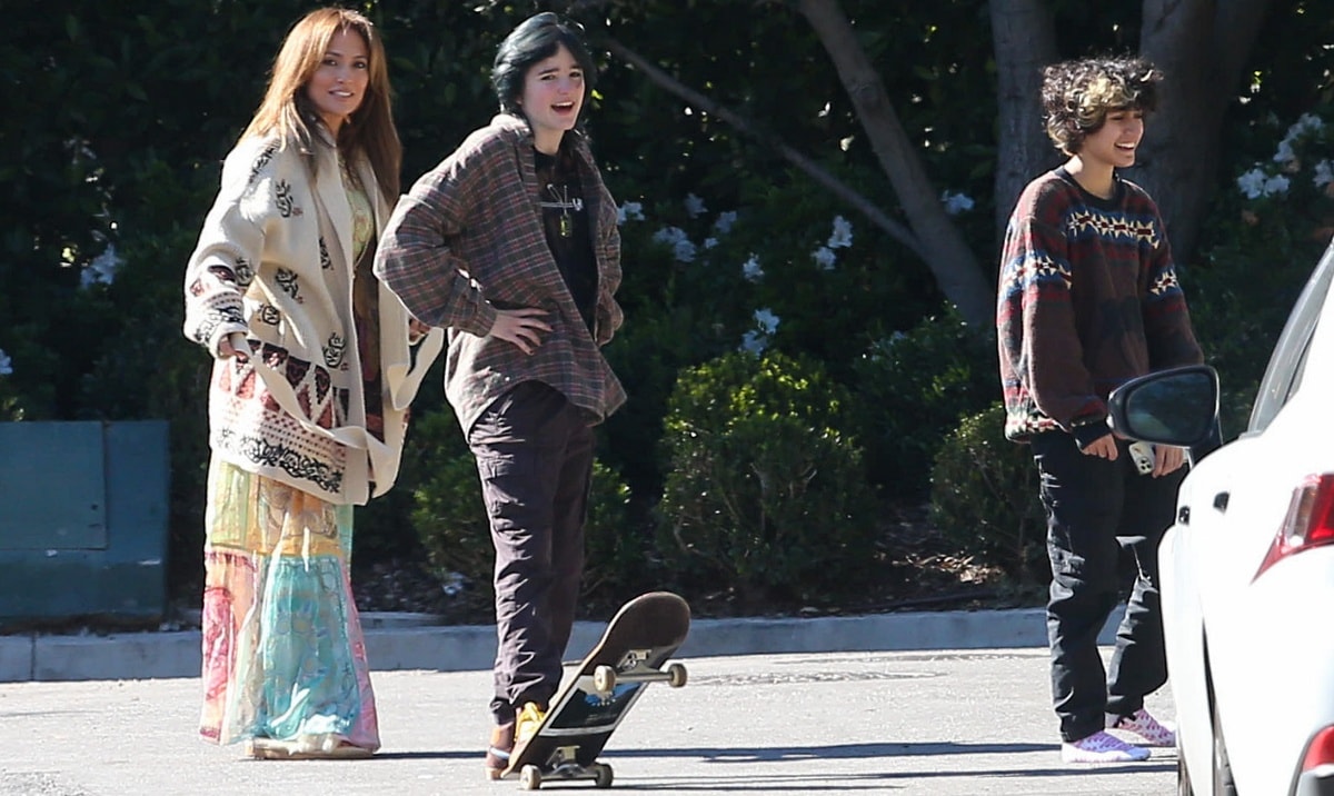 Jennifer Lopez embraces laid-back boho style in a flowing patchwork sundress layered with a cream Dior cardigan and flat sandals while spending time with her kids