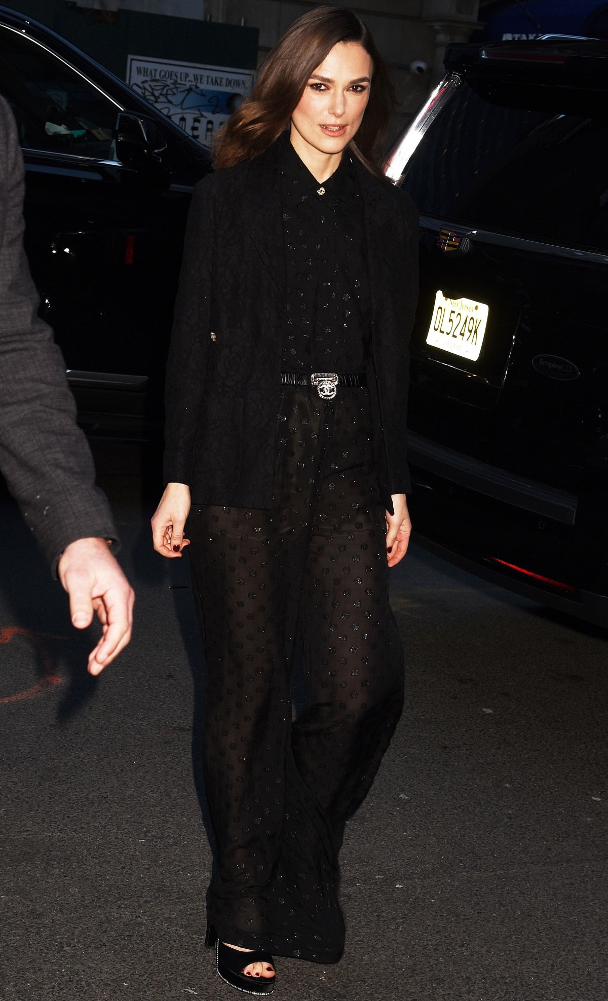 Keira Knightley closes her Boston Strangler press tour in a semi-sheer black lace Chanel ensemble styled with a jeweled belt and matching satin sandals for a sophisticated monochrome finale in New York City