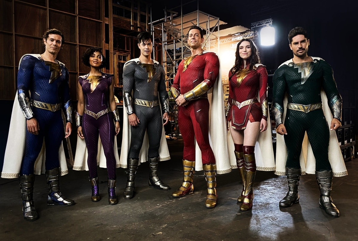 The superheroes from Shazam! Fury of the Gods stand together in their updated costumes, showcasing the diverse cast ready for action