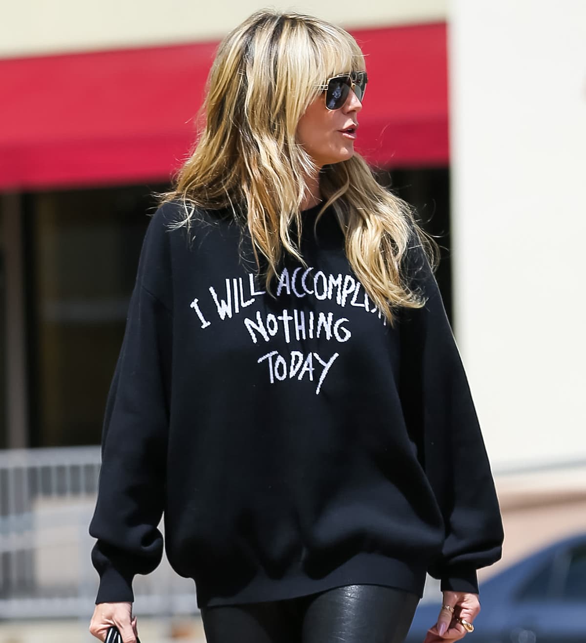Teddy Fresh's "I Will Accomplish Nothing Today" sweater features a statement jacquard artwork on the front, a matte embossed silicone label at the center back neckline, and ribbed neckband, cuffs, and waistband
