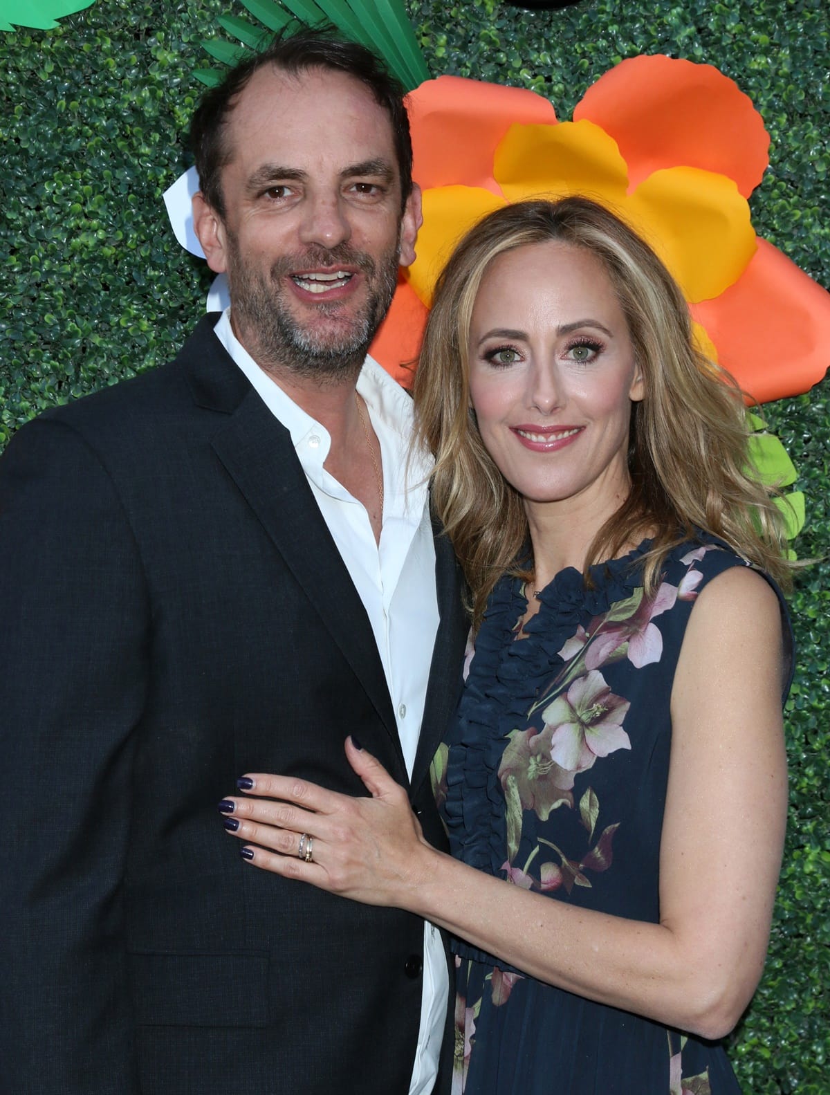 Kim Raver looked elegant in a navy floral dress while posing with her husband, filmmaker Manu Boyer, at a Los Angeles event