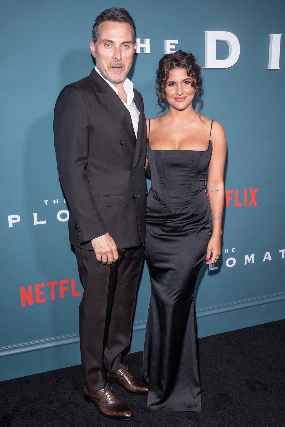Posing with his girlfriend Vivian Benitez, Rufus Sewell looked dapper in a double-breasted black suit paired with polished brown oxford shoes at The Diplomat premiere