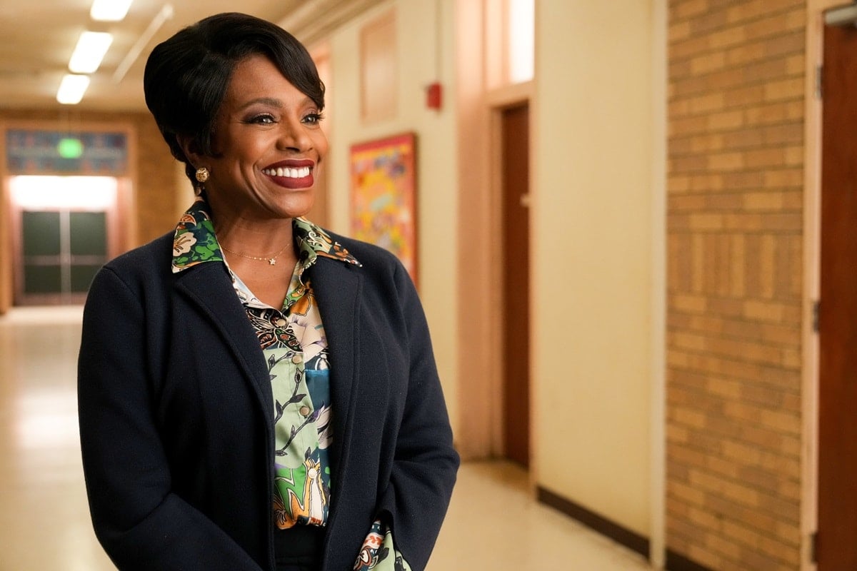Emmy-winning actress Sheryl Lee Ralph, who stands 5 feet 6¾ inches tall, radiates elegance in a navy blazer layered over a vibrant printed blouse while portraying Barbara Howard in Abbott Elementary