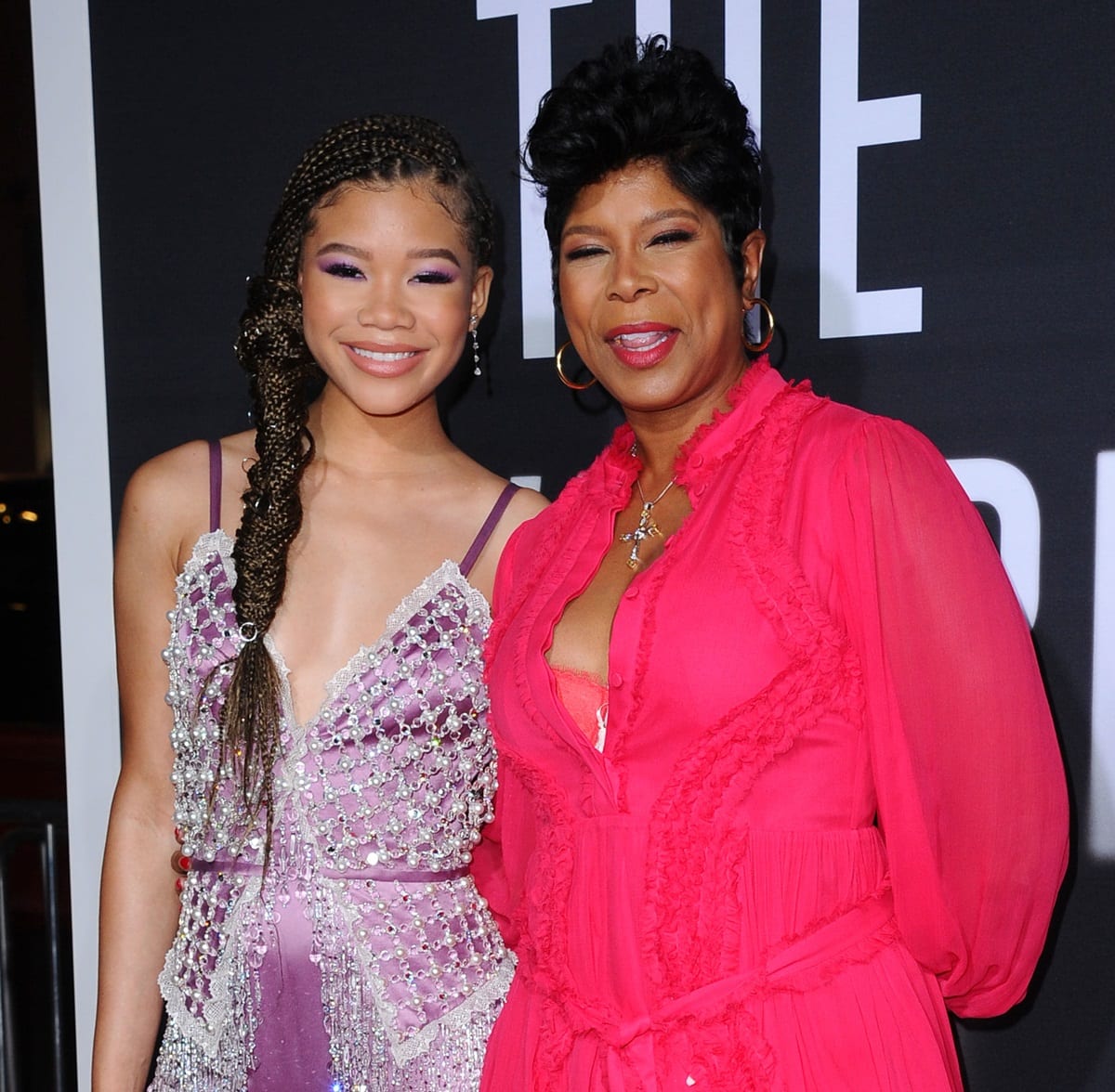 Storm Reid attends the premiere of “The Invisible Man” with her mother, Robyn Simpson Reid, dazzling in a lilac crystal-embellished Miu Miu gown while Robyn complements her in a bold fuchsia dress—perfectly capturing their close bond and shared sense of style