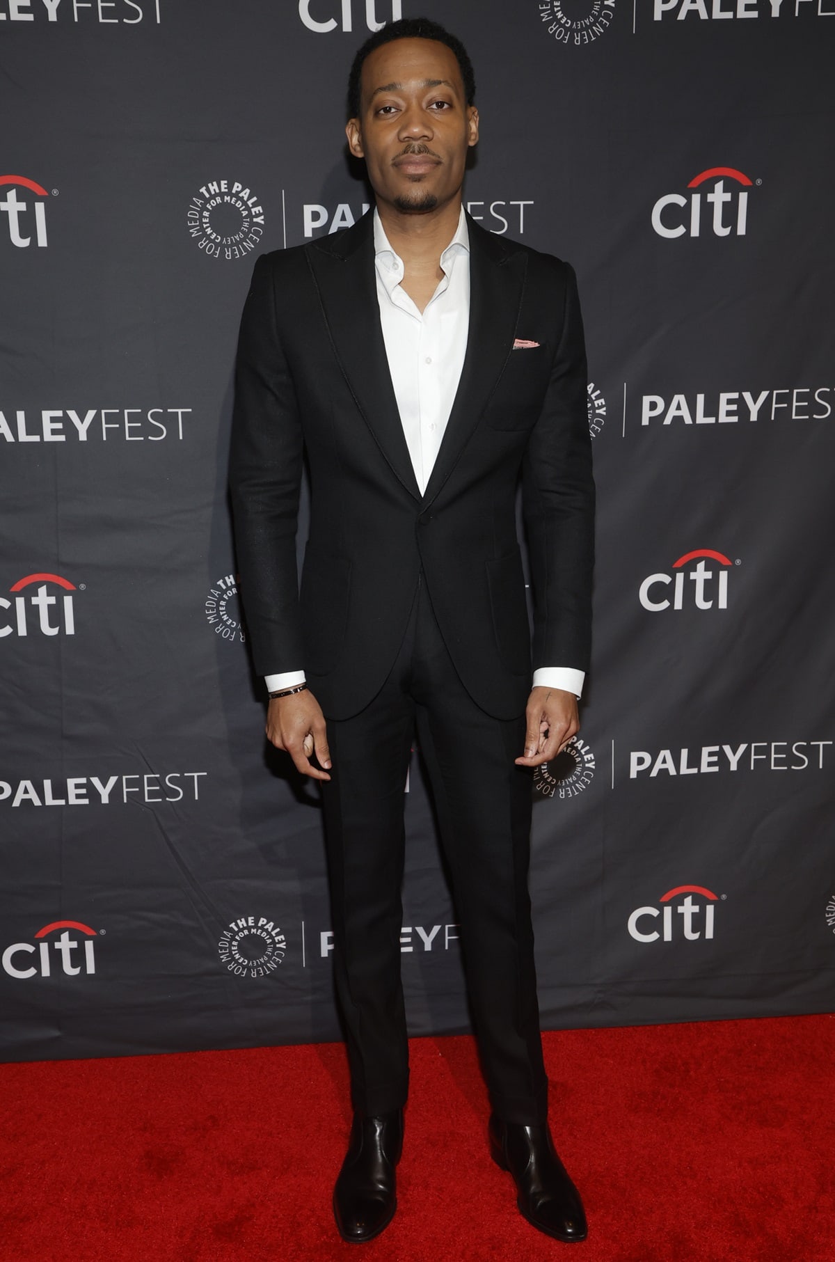 Tyler James Williams looks sharp in a tailored black suit with sleek leather Chelsea boots at the 2023 PaleyFest LA, held at the Dolby Theatre in Hollywood