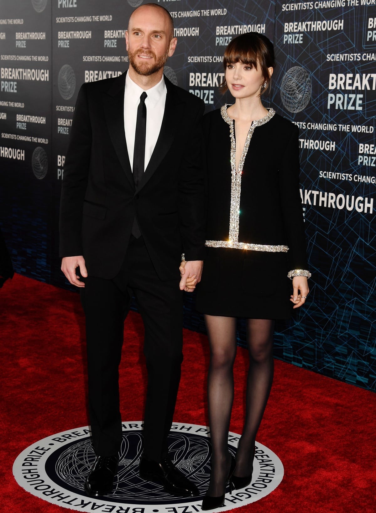 Charlie McDowell complemented Lily Collins’ sleek pointed-toe pumps in a sharp black Celine suit, creating a perfectly coordinated monochrome moment on the red carpet