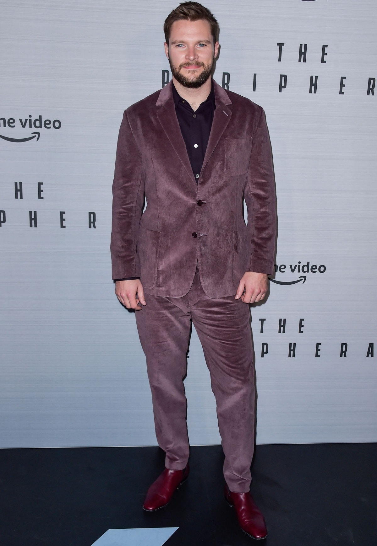 Jack Reynor stood out at The Peripheral Los Angeles premiere in a bold mauve corduroy suit styled with a black shirt and striking deep red leather boots for a refined yet fashion-forward finish