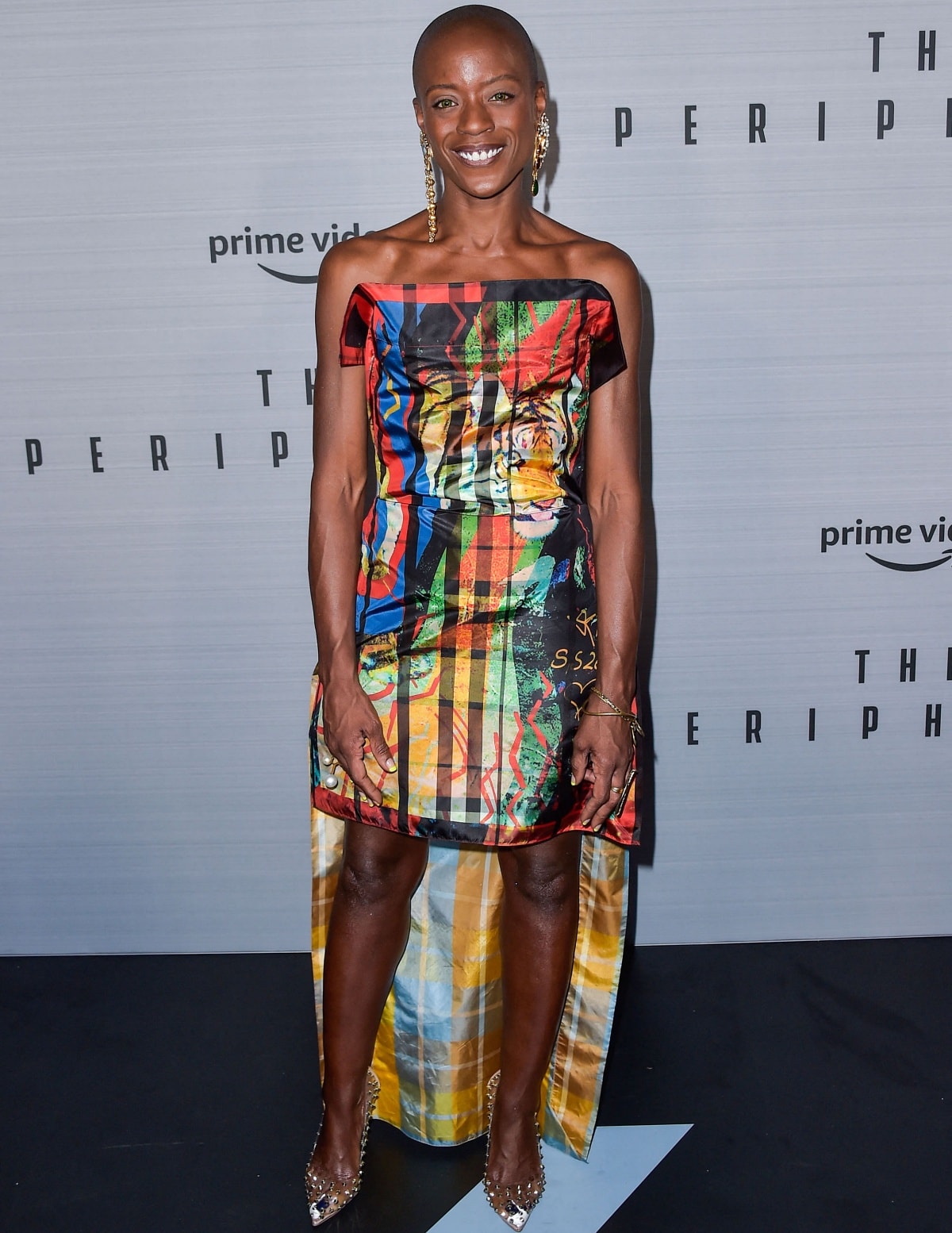 T’Nia Miller lit up the Los Angeles premiere of The Peripheral in a vibrant, graphic strapless dress paired with crystal-embellished pointed-toe pumps, proving that bold color and effortless confidence make the ultimate red-carpet statement