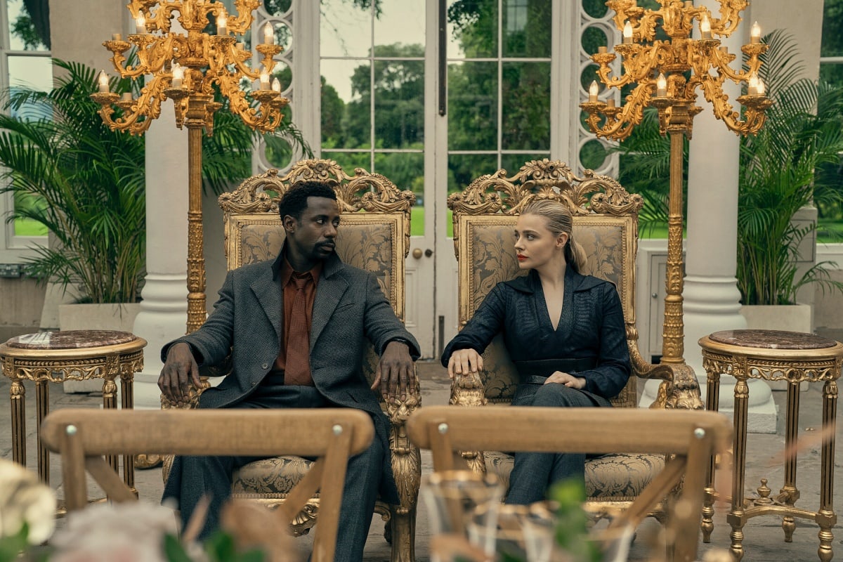 Gary Carr and Chloë Grace Moretz portray Wilf Netherton and Flynne Fisher in The Peripheral, captured in Michele Clapton’s elegantly contrasting costume design of futuristic tailoring and gilded excess