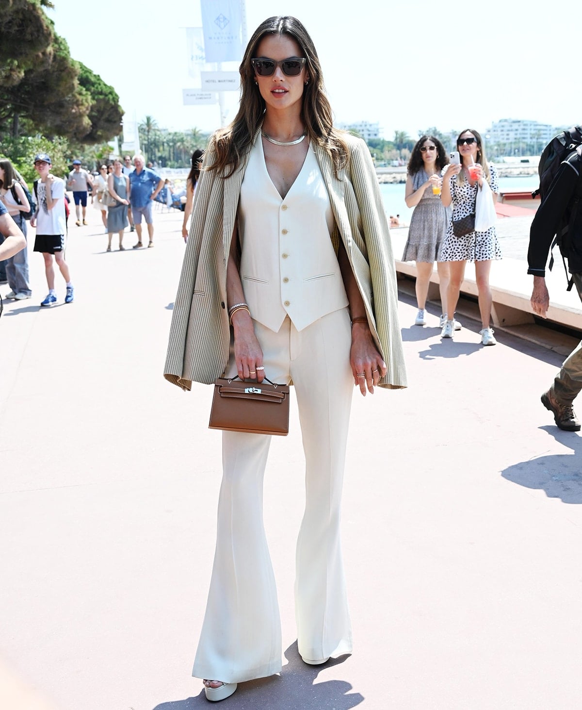 Alessandra Ambrosio heads to the Barbie x Tangle Teezer launch event in Cannes in a three-piece menswear-inspired Petar Petrov ensemble on May 22, 2023