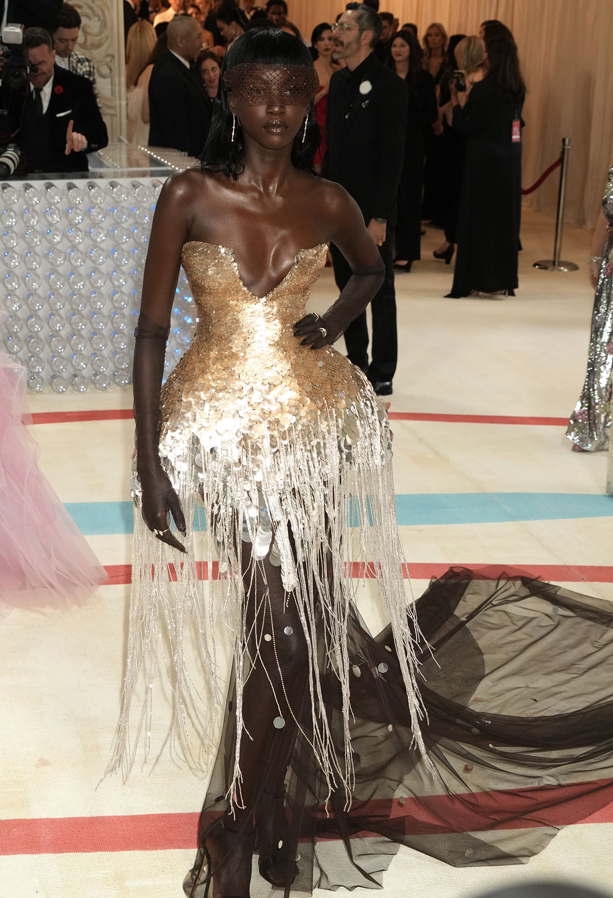 Anok Yai made a stunning appearance at the 2023 Met Gala, wearing a mesmerizing Prabal Gurung jellyfish pannier dress that was meticulously hand-embroidered with oxidized gold and silver dégradé sequin paillettes
