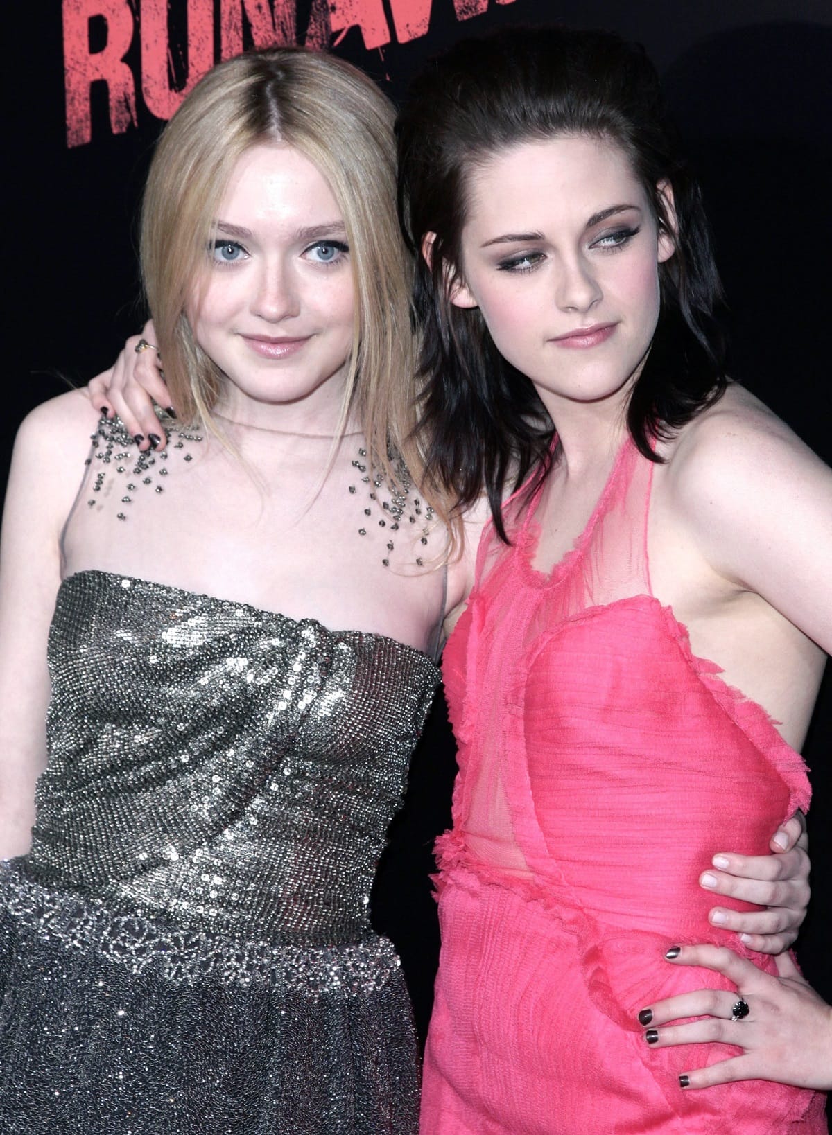 Dakota Fanning dazzles in a silver embellished strapless dress, while Kristen Stewart turns heads in a sheer pink halter gown at The Runaways premiere