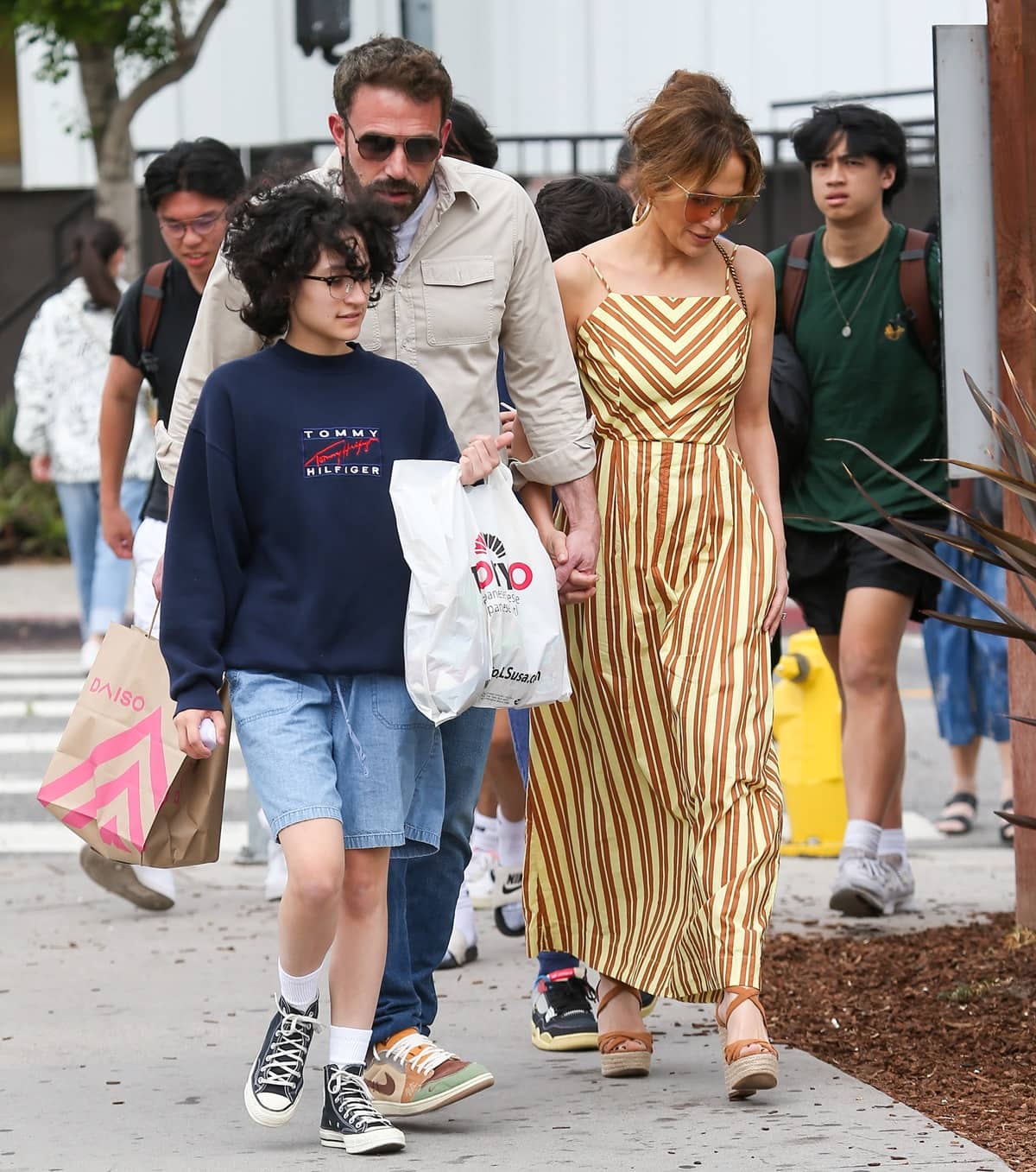 Ben Affleck and Jennifer Lopez held hands during a stroll and were accompanied by Jennifer's 15-year-old child, Emme Maribel Muñiz, on May 20, 2023, in Los Angeles, California