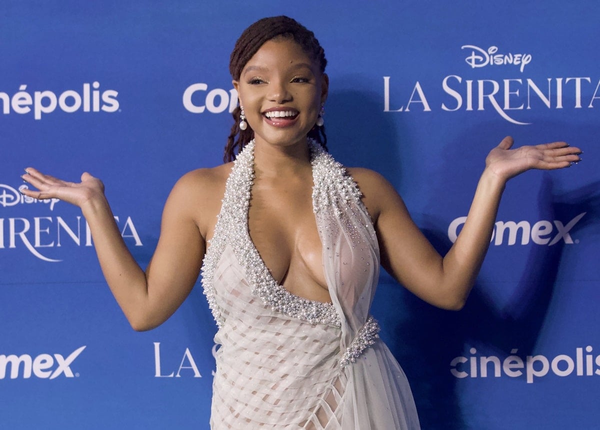 Halle Bailey commands attention in a sheer pale blue Georges Chakra gown featuring a pearl-embellished halter neckline and plunging bodice designed to accentuate her cleavage