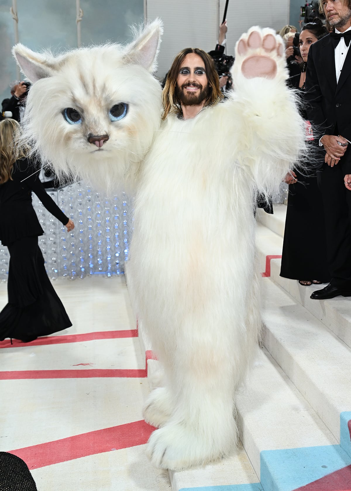 Jared Leto removes his huge cat headpiece to reveal his identity
