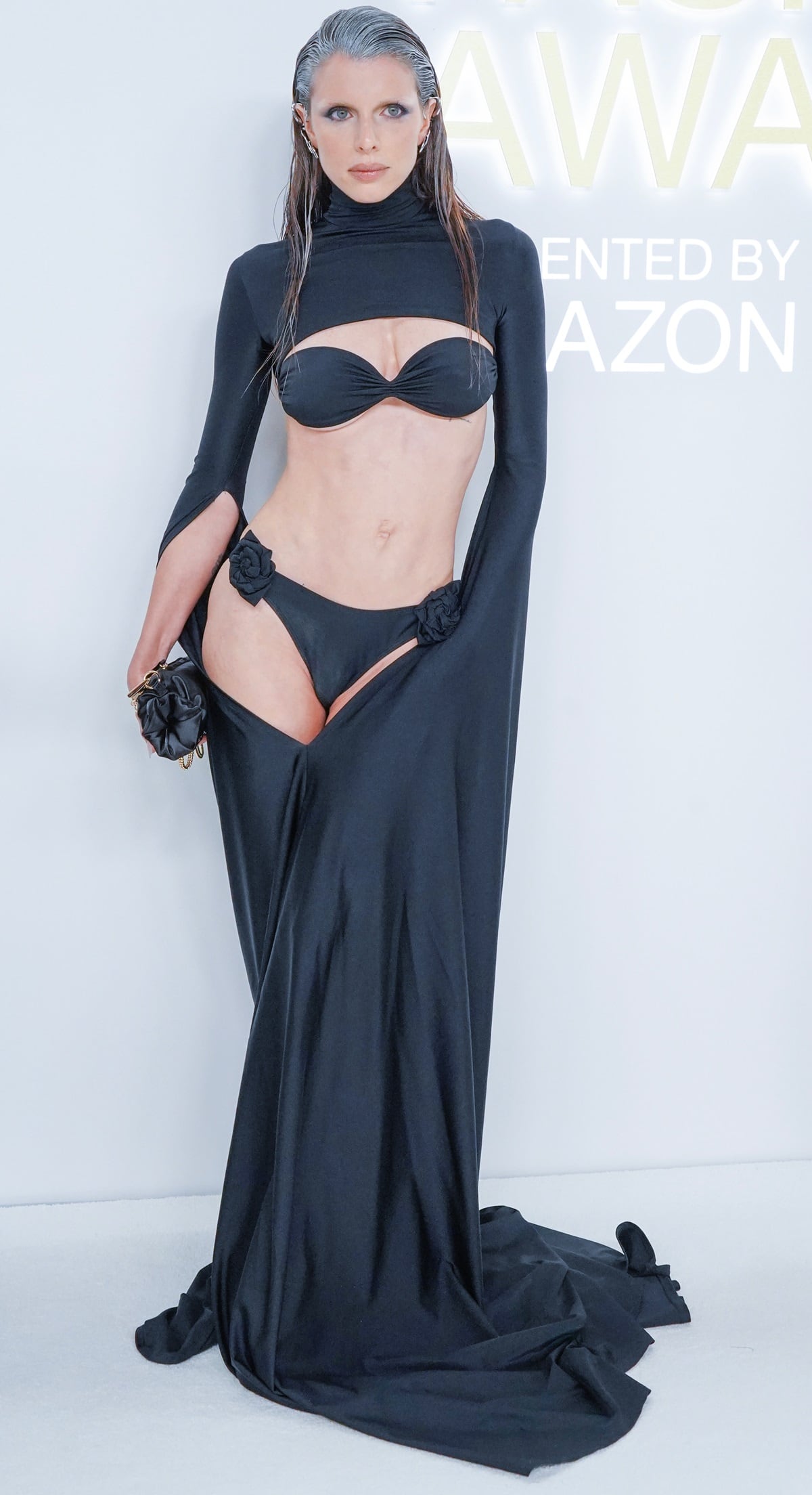 Julia Fox walked the red carpet with wet strands of her natural brown hair slicked back, with gray dye visible at the roots, at the 2022 CFDA Fashion Awards
