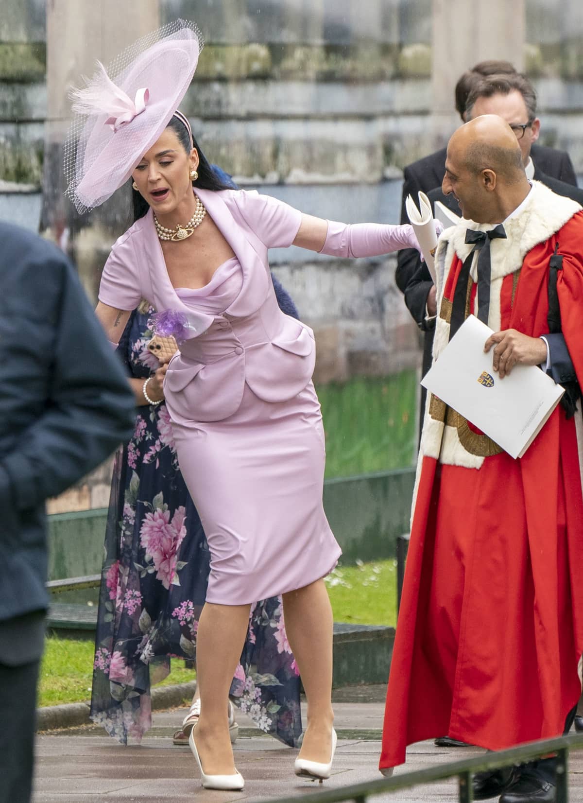 Katy Perry briefly lost her balance while leaving Westminster Abbey in ivory pointed-toe pumps and a lilac Vivienne Westwood ensemble after the Coronation of King Charles III and Queen Camilla on May 6, 2023