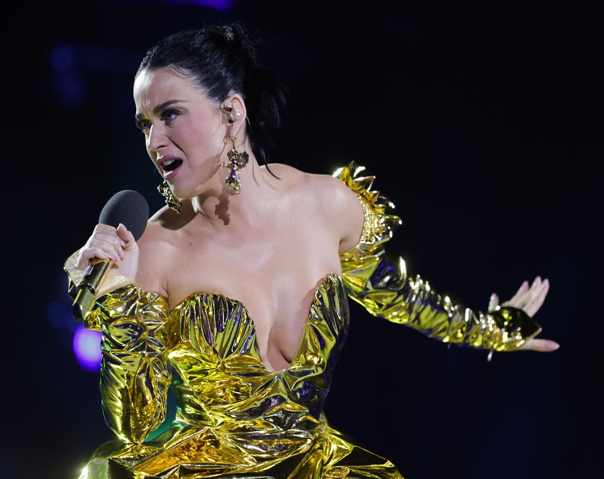 Katy Perry graced the stage in a magnificent gold metallic leatherette gown by the renowned designer Vivienne Westwood, featuring a beautifully sculpted bodice and a plunging neckline inspired by 18th-century fashion