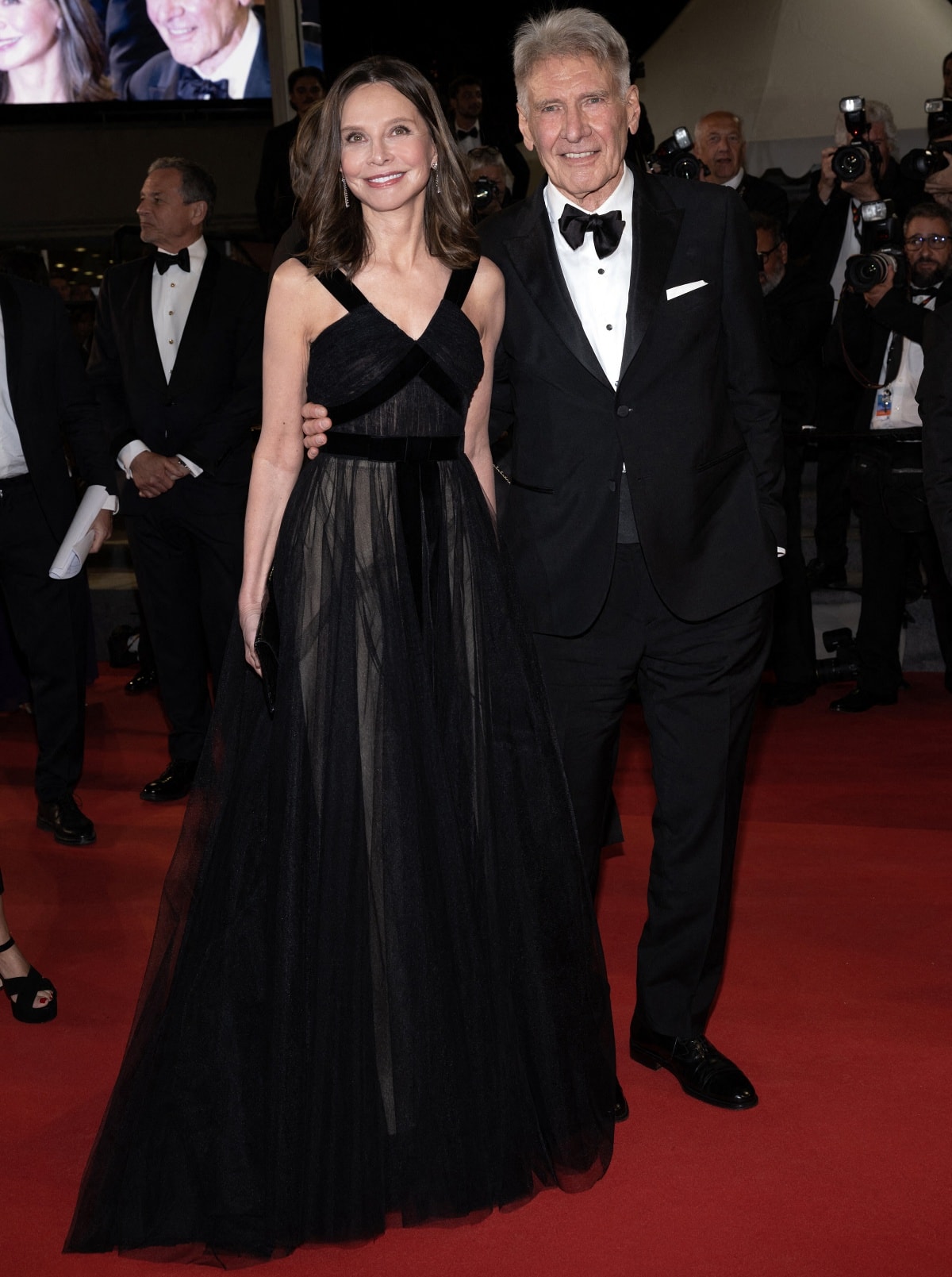 Calista Flockhart and Harrison Ford share a radiant moment on the red carpet at the Indiana Jones and the Dial of Destiny premiere during the 76th Cannes Film Festival